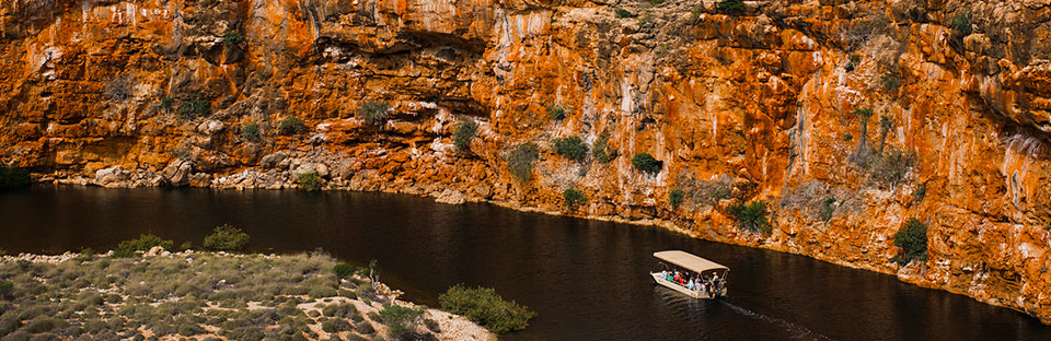 The Yardie Creek Boat Tour vessel, 'Yardi' meanders along the creek below the escarpment walls.